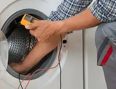 Washing machine repair technician testing a front-load washer with diagnostic tools in Pasadena, CA