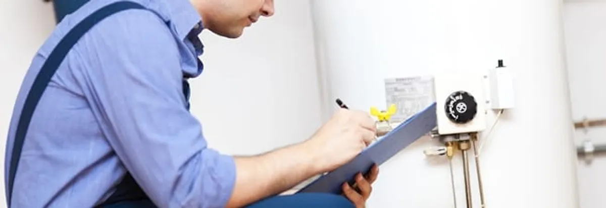 Water heater repair technician inspecting the unit and recording service notes in Pasadena, CA